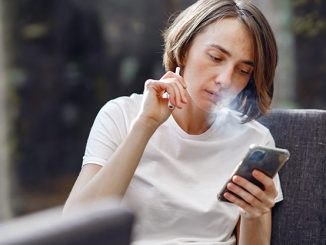 Photo by Gustavo Fring: https://www.pexels.com/photo/woman-smoking-while-holding-her-phone-4017434/